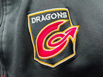 Go to Embroidery Page Embroidered black and red Dragons logo on coat