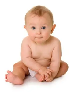 Baby sitting and smiling