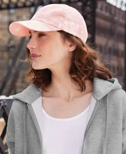 Woman with long hair and a pink baseball hats